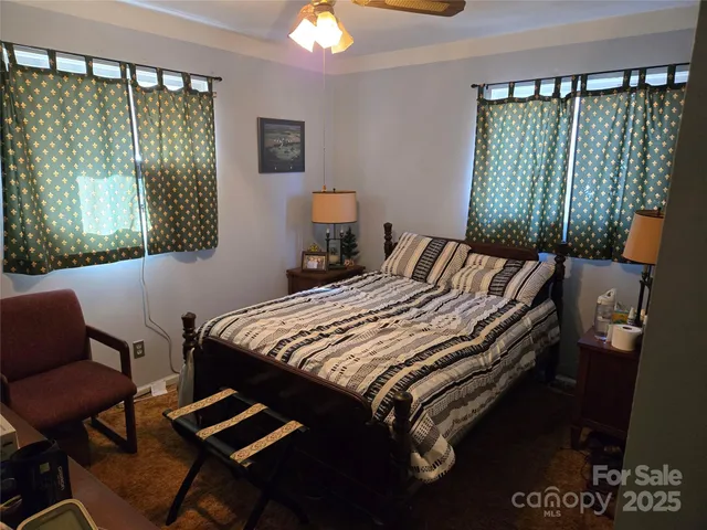 a bedroom with a bed window and a couch