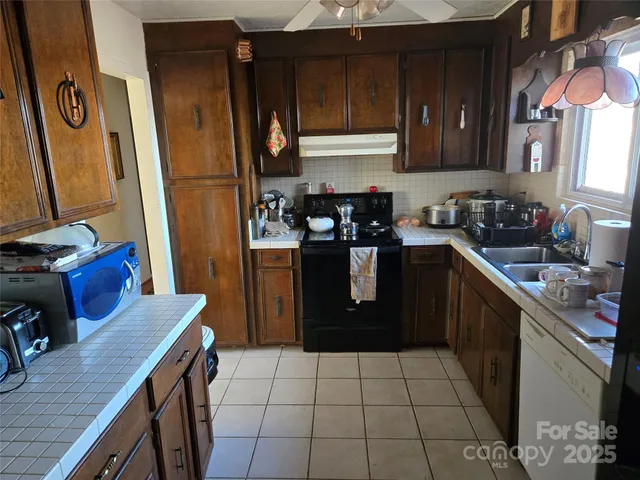 a kitchen with a sink a stove and refrigerator