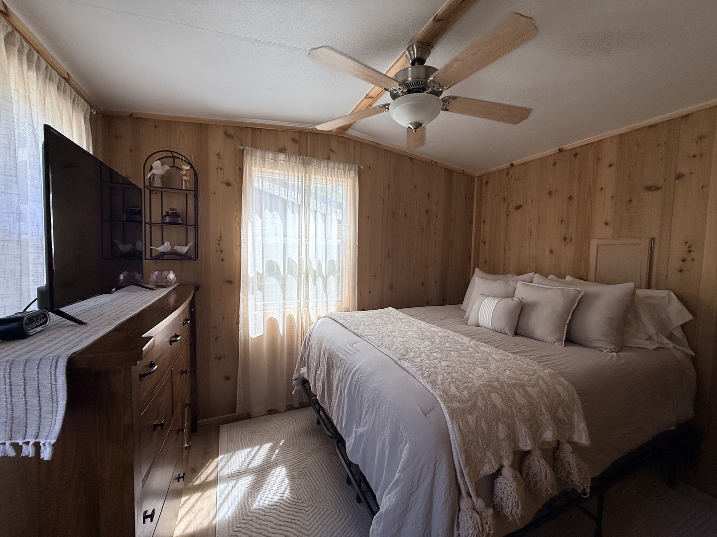 25-4 Woodhaven Lakes Sublette, IL 61367 - Photo 24 of 26 a bedroom with a large bed and a flat tv screen on dresser