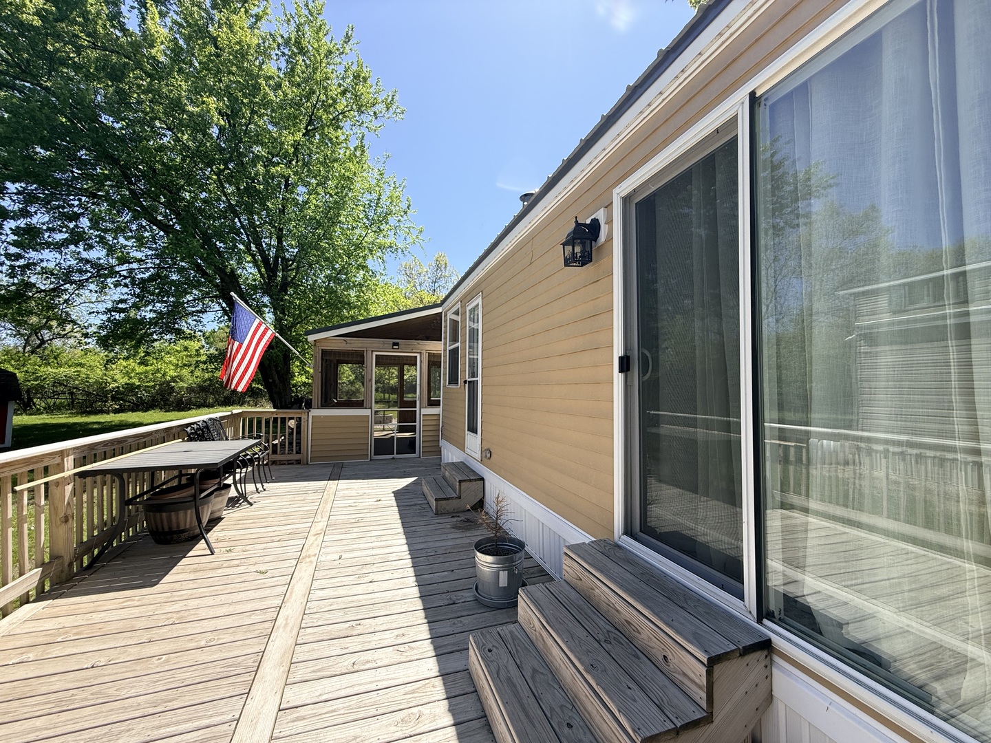 25-4 Woodhaven Lakes Sublette, IL 61367 - Photo 8 of 26 a balcony with couch and wooden floor