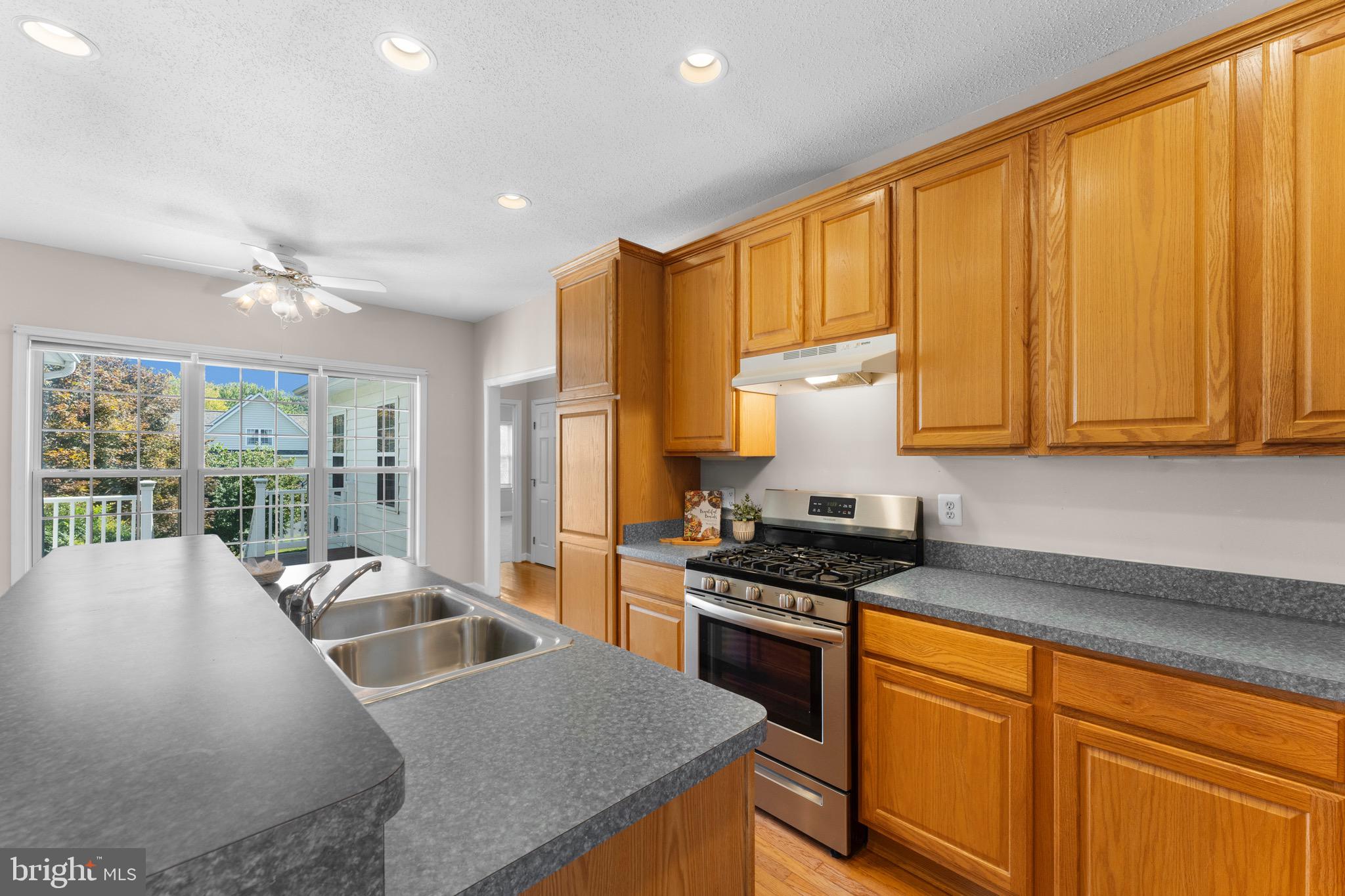 19065 Stallion Road Culpeper, VA 22701 - Photo 17 of 40 a kitchen with stainless steel appliances granite countertop a sink a stove and a refrigerator