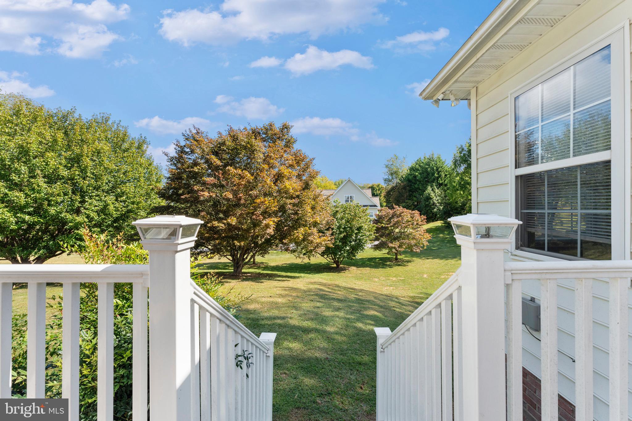 19065 Stallion Road Culpeper, VA 22701 - Photo 38 of 40 a view of a brick house with a yard and large trees