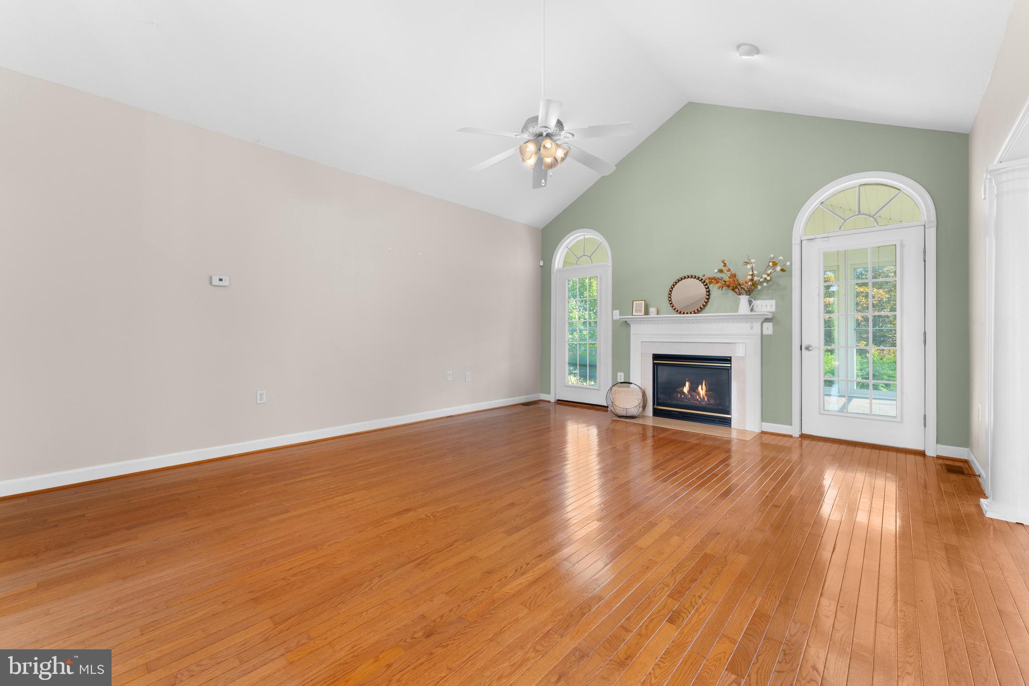 19065 Stallion Road Culpeper, VA 22701 - Photo 8 of 40 a view of an empty room with wooden floor fireplace and a window