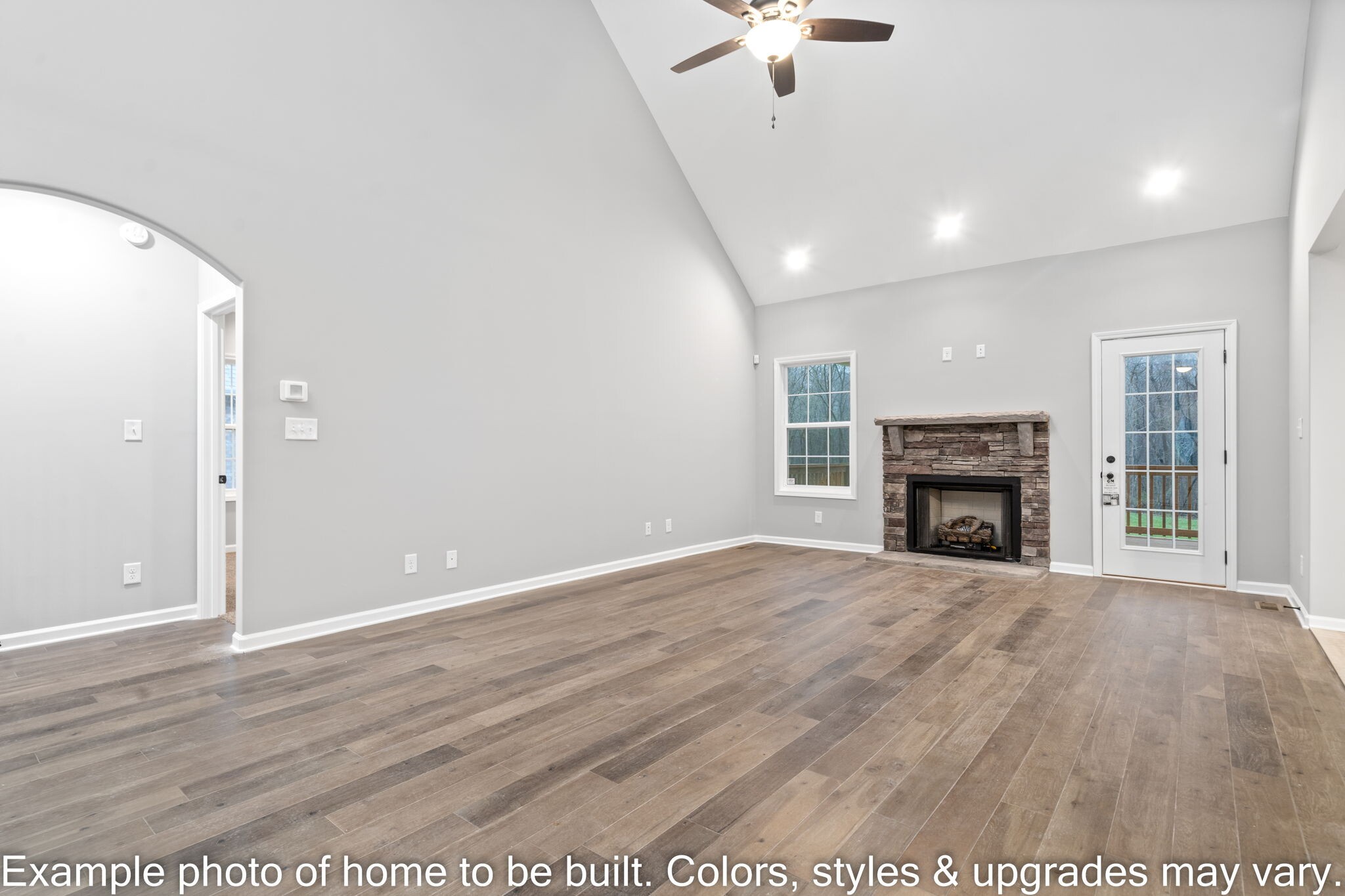 929 Inverness Lane Clarksville, TN 37043 - Photo 6 of 42 an empty room with wooden floor fireplace and windows