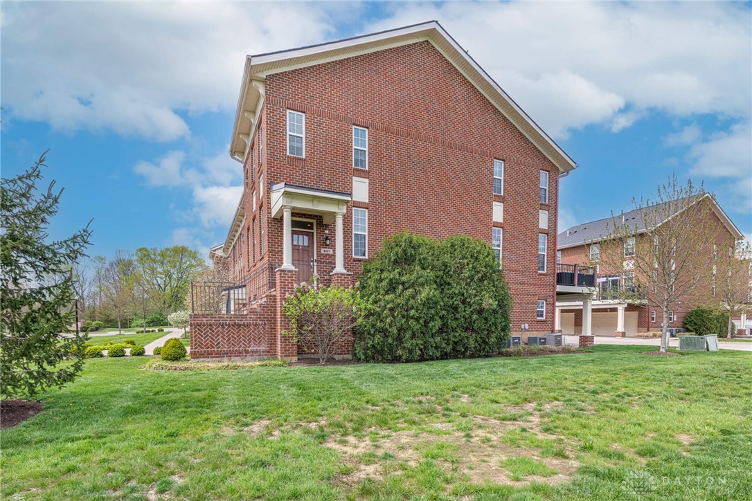 407 Brownstone Row Springboro, OH 45066 - Photo 4 of 54 This classic brick townhome offers a welcoming facade with traditional architectural elements.