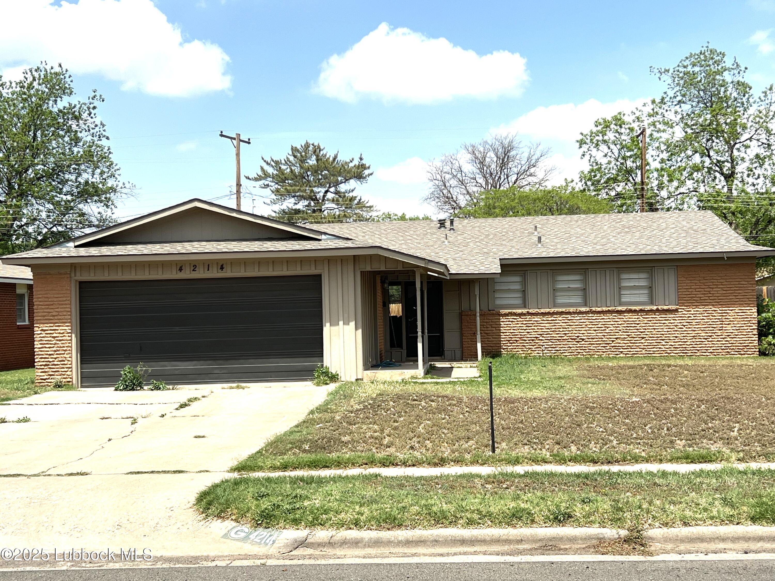 4214 54th Street Lubbock, TX 79413 - Photo 1 of 18 a front view of a house with garden