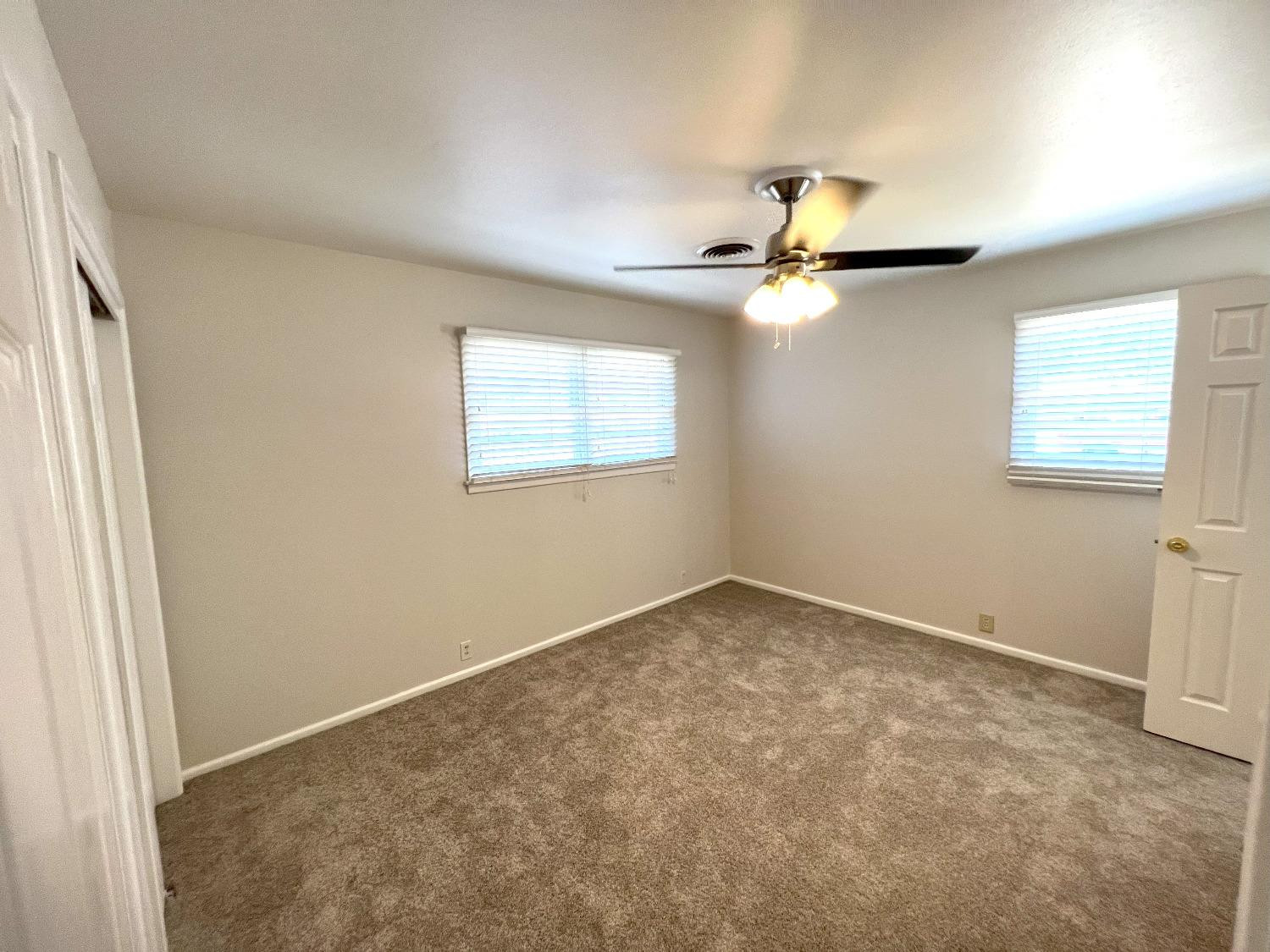 4214 54th Street Lubbock, TX 79413 - Photo 11 of 18 an empty room with windows and fan