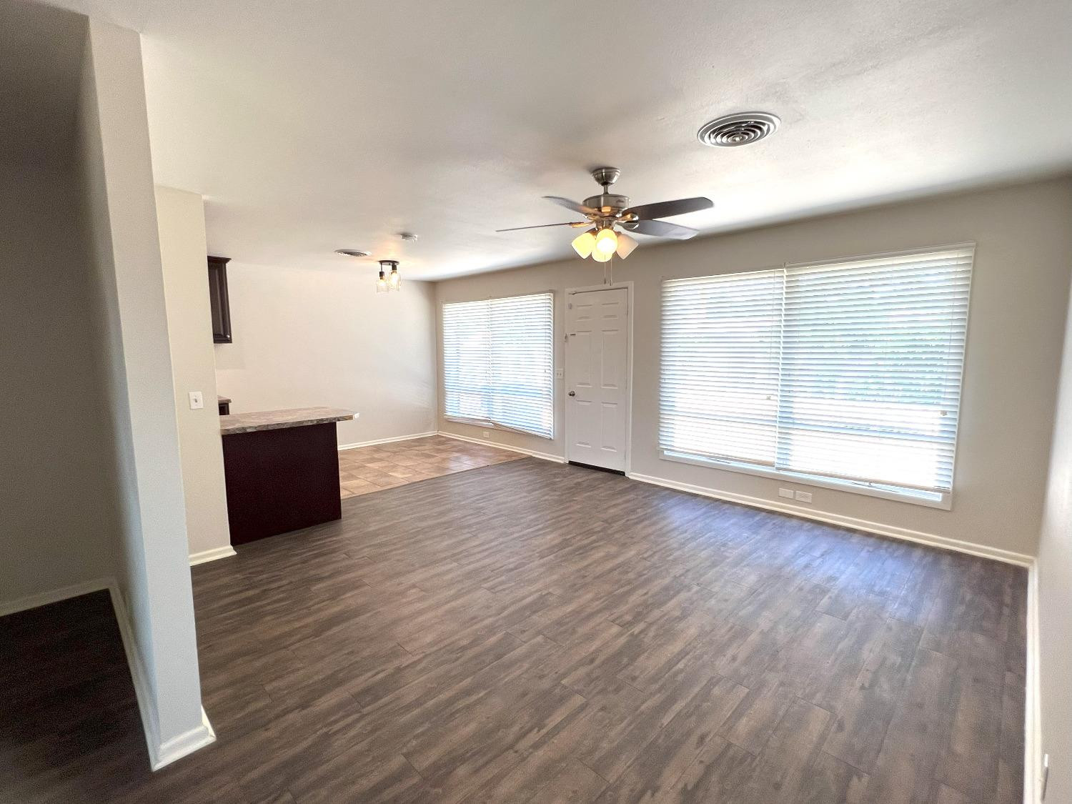 4214 54th Street Lubbock, TX 79413 - Photo 14 of 18 an empty room with wooden floor and windows