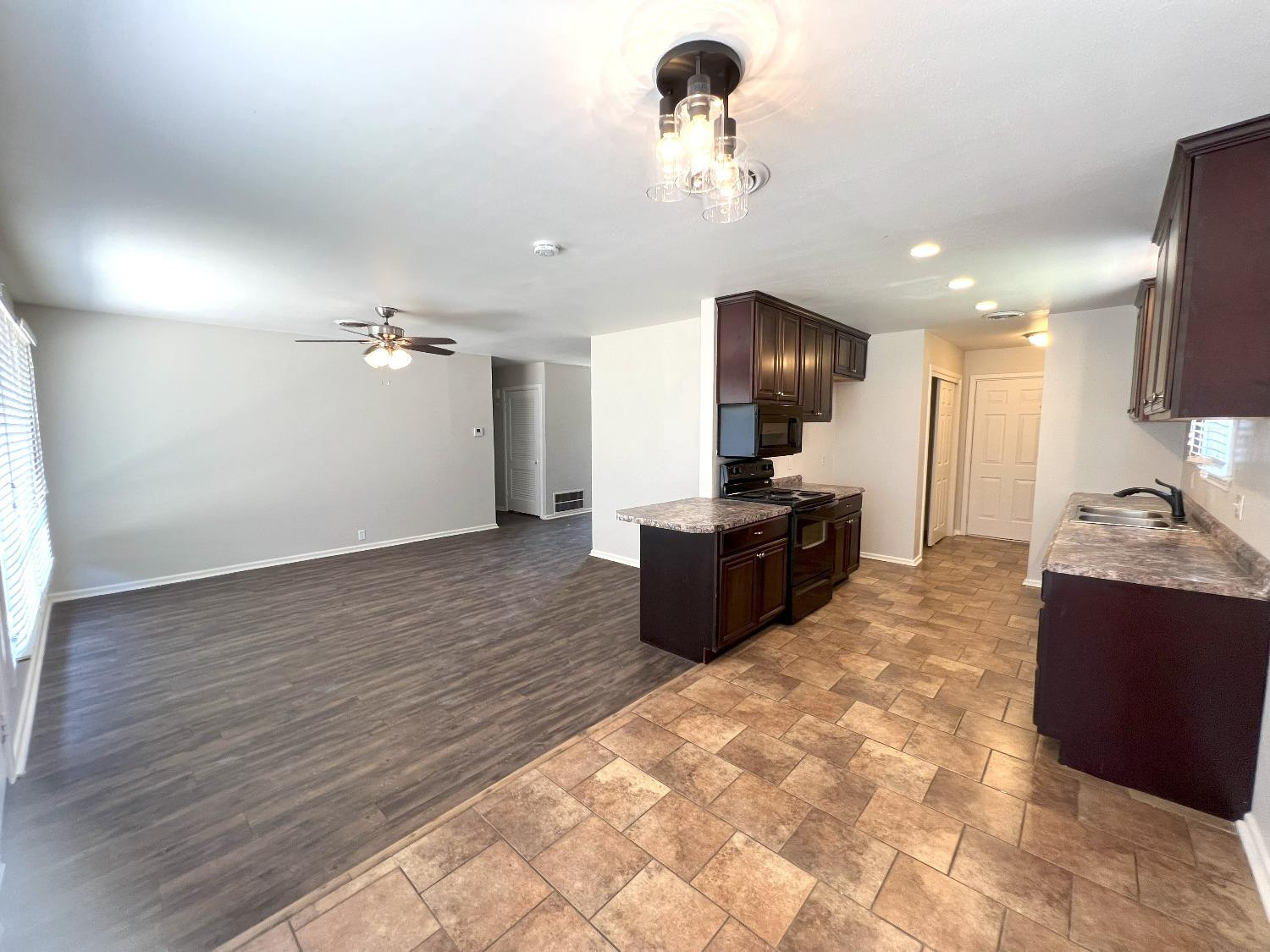 4214 54th Street Lubbock, TX 79413 - Photo 15 of 18 a large room with a large window and kitchen view