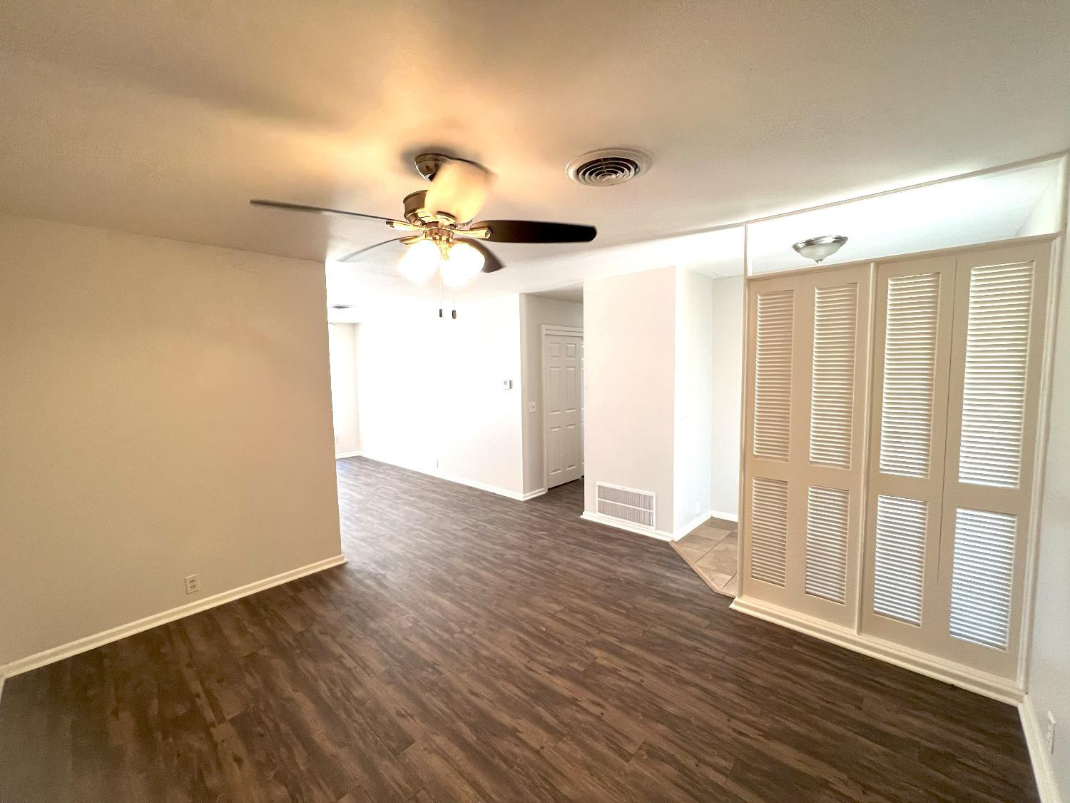 4214 54th Street Lubbock, TX 79413 - Photo 4 of 18 an empty room with wooden floor fan and windows