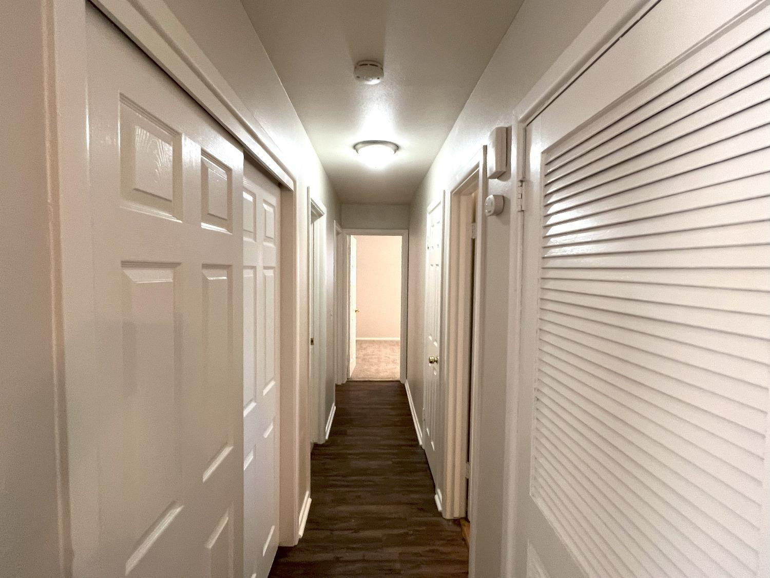 4214 54th Street Lubbock, TX 79413 - Photo 5 of 18 a view of a hallway with wooden floor and staircase