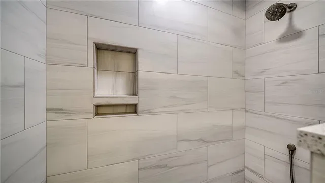 a bathroom with a sink shower and a mirror