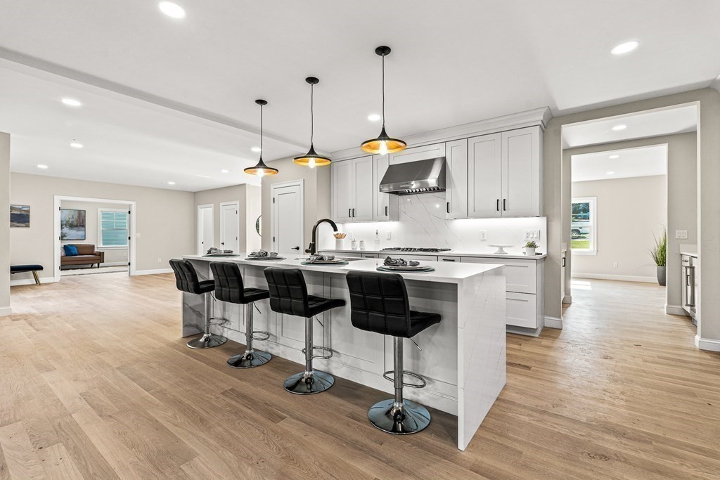 228 Ridge Street Winchester, MA 01890 - Photo 11 of 42 a kitchen with stainless steel appliances kitchen island a stove a table and chairs in it