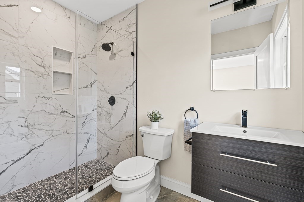 228 Ridge Street Winchester, MA 01890 - Photo 17 of 42 a bathroom with a sink a toilet and shower