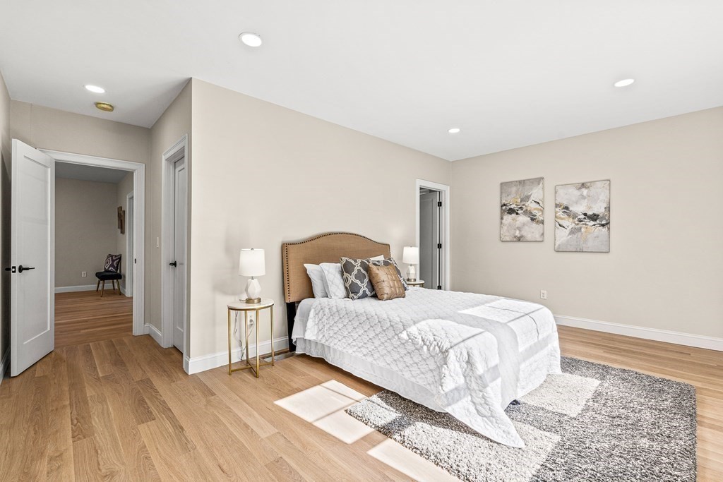 228 Ridge Street Winchester, MA 01890 - Photo 18 of 42 a bedroom with a large bed and a chandelier