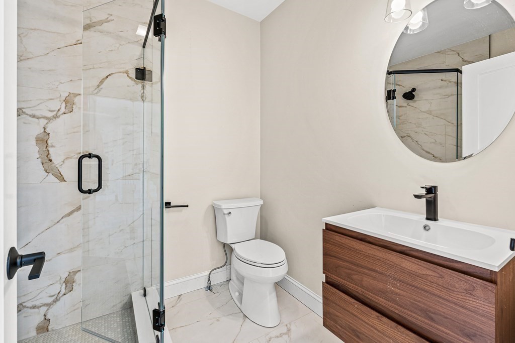 228 Ridge Street Winchester, MA 01890 - Photo 23 of 42 a bathroom with a sink a toilet and a mirror