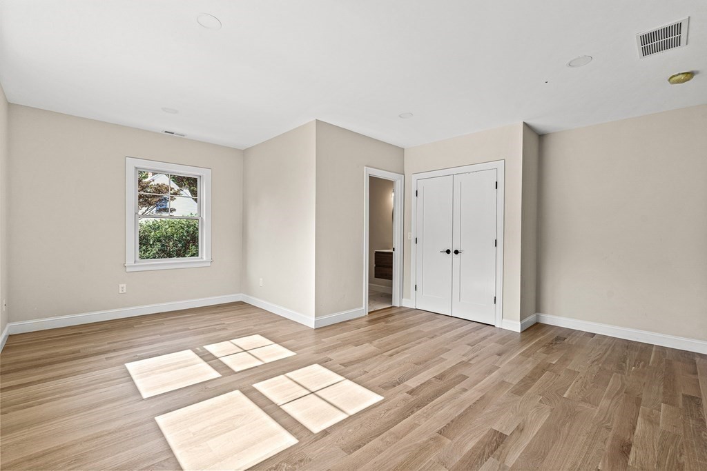 228 Ridge Street Winchester, MA 01890 - Photo 24 of 42 a view of an empty room with wooden floor and a window