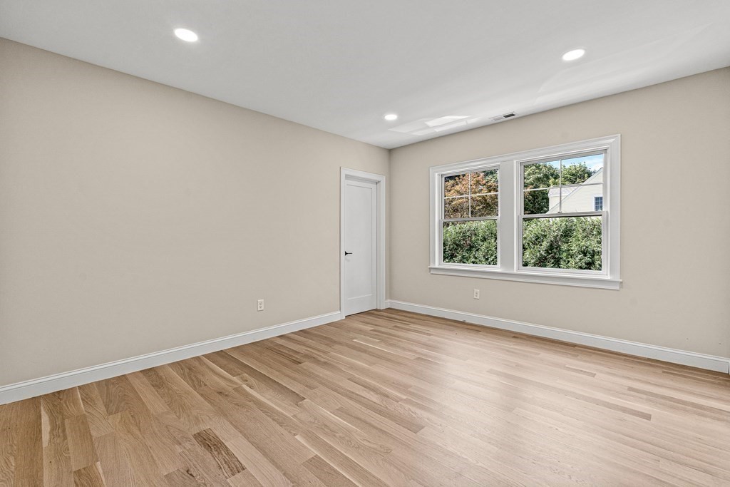 228 Ridge Street Winchester, MA 01890 - Photo 25 of 42 a view of an empty room with wooden floor and a window