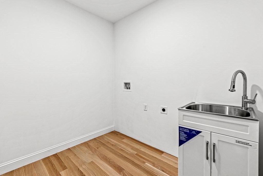 228 Ridge Street Winchester, MA 01890 - Photo 27 of 42 a close view of a sink and dishwasher with wooden floor
