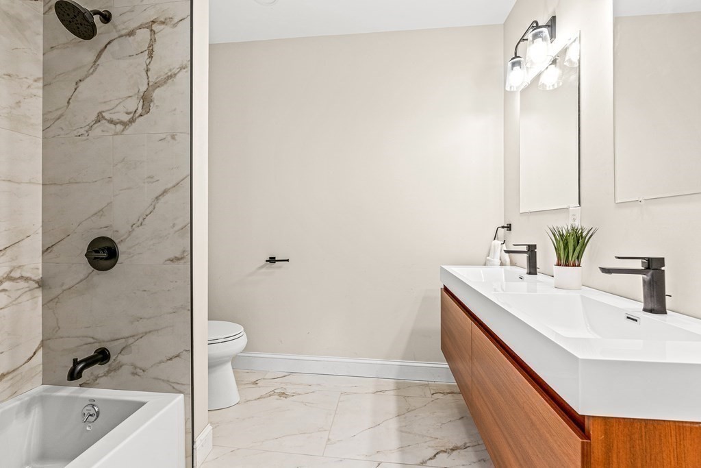 228 Ridge Street Winchester, MA 01890 - Photo 32 of 42 a bathroom with a sink a toilet and shower