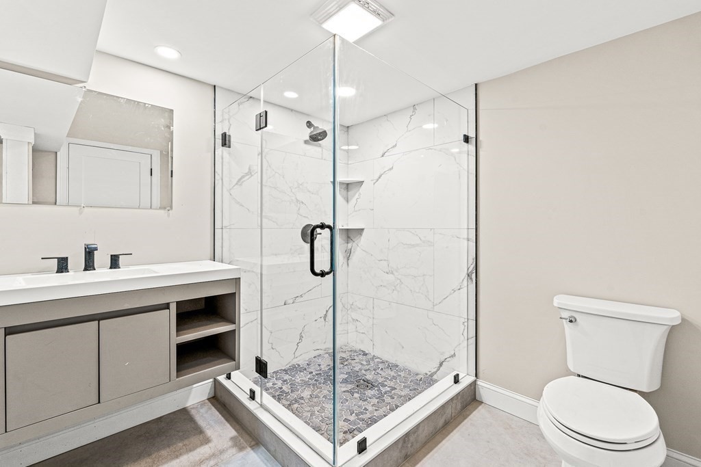 228 Ridge Street Winchester, MA 01890 - Photo 35 of 42 a bathroom with a shower sink mirror and toilet