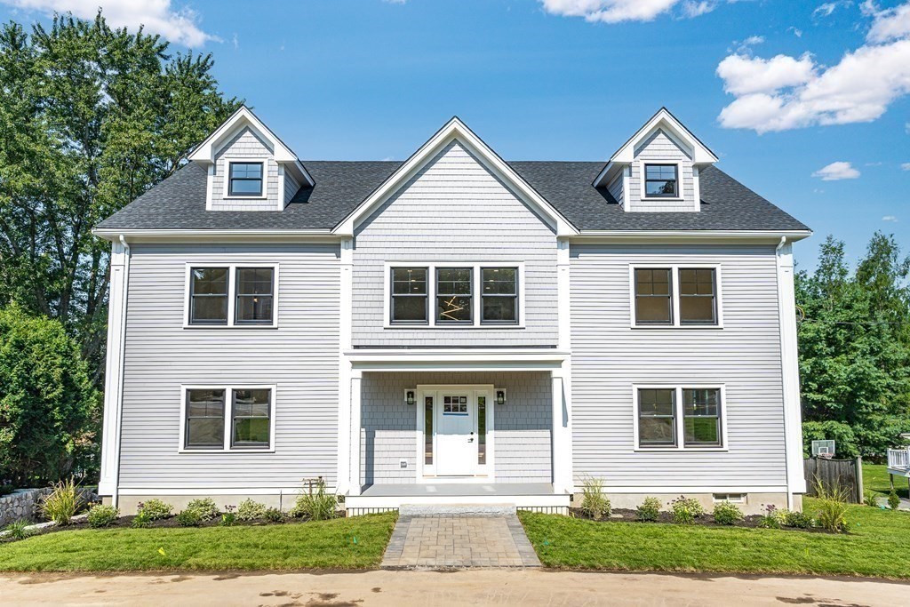 228 Ridge Street Winchester, MA 01890 - Photo 40 of 42 a front view of a house with a yard and garage