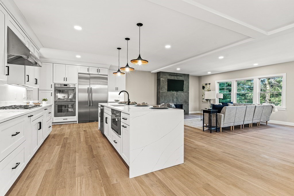 228 Ridge Street Winchester, MA 01890 - Photo 8 of 42 a large kitchen with stainless steel appliances granite countertop a large center island and a wooden floors