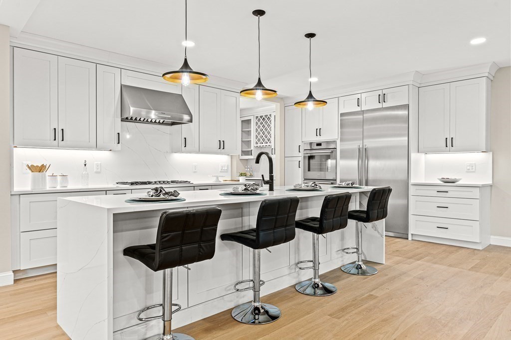 228 Ridge Street Winchester, MA 01890 - Photo 9 of 42 a kitchen with cabinets and chairs