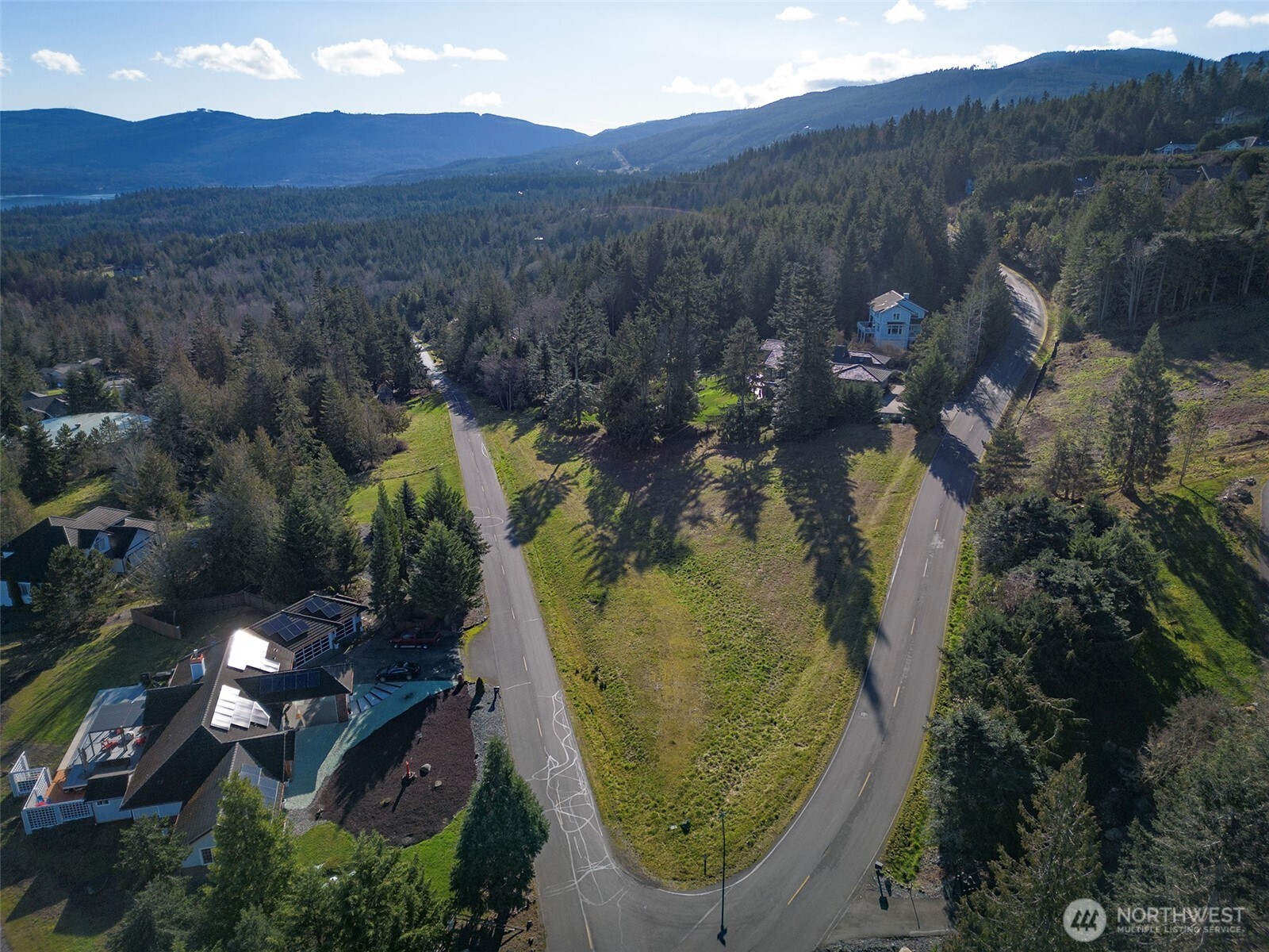 9999 Doe Run Road Sequim, WA 98382 - Photo 33 of 36 an aerial view of a house with mountain view