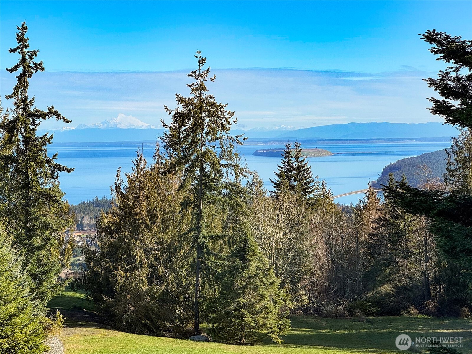 9999 Doe Run Road Sequim, WA 98382 - Photo 5 of 36 a view of a lake with a garden