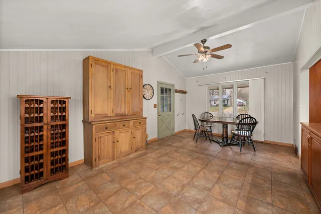 a view of kitchen with furniture and refrigerator