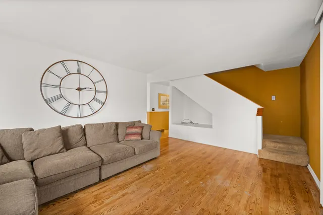 a living room with a couch and a potted plant