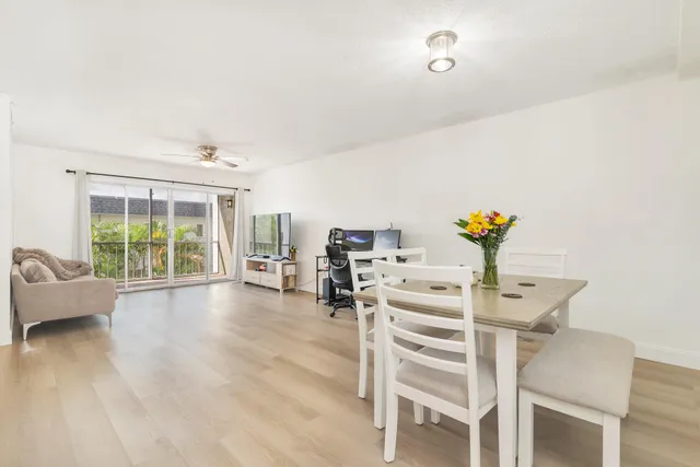 a view of a dining room with furniture and a wooden floor