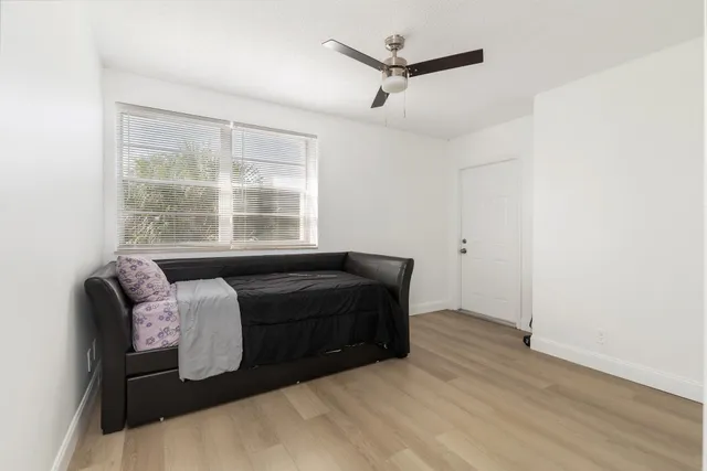 a living room with a bed furniture and a window