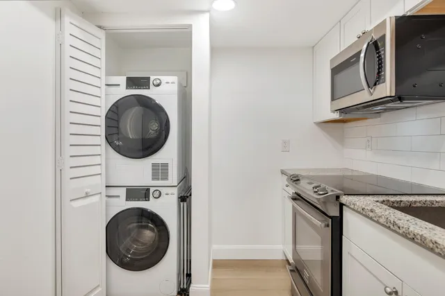 a view of a kitchen with washer and dryer