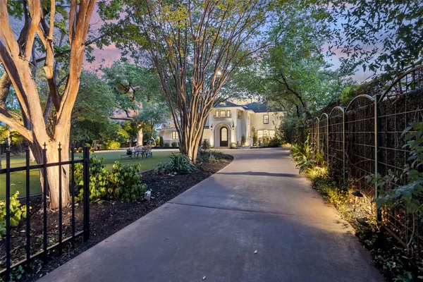 a pathway of a house with a yard