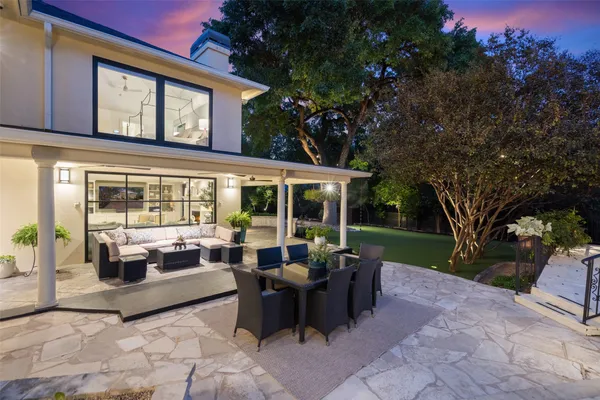 a outdoor dining space with furniture and city view