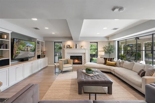 a dining room with furniture a chandelier and wooden floor