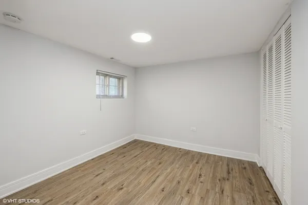 a view of a room with wooden floor and white walls