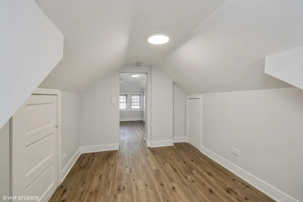 a view of a room with wooden floor and window
