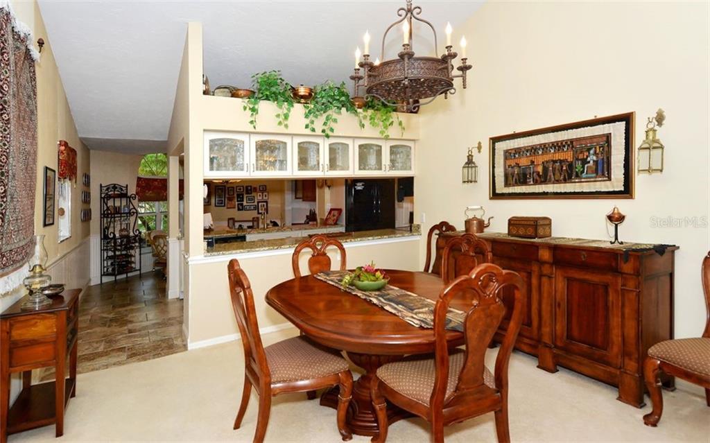 275 Woods Point Road Osprey, FL 34229 - Photo 10 of 40 Gracious, open dining area. Chandelier not conveying.