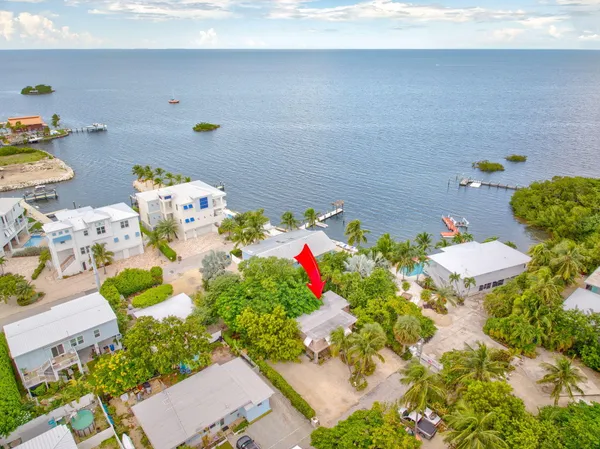 a bathroom with a sink mirror and flowers