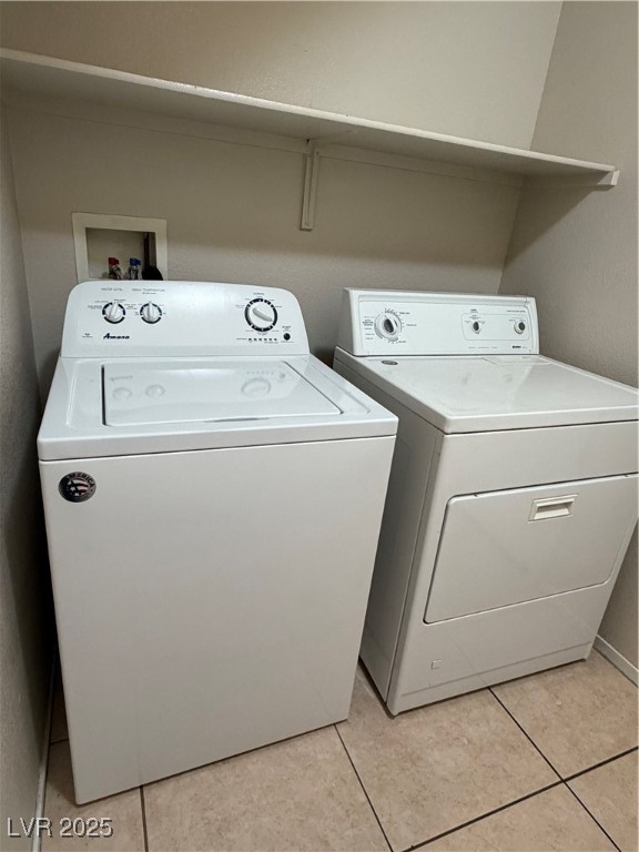 2924 Covatta Court North Las Vegas, NV 89086 - Photo 11 of 27 Washroom with washer and clothes dryer and light tile patterned floors