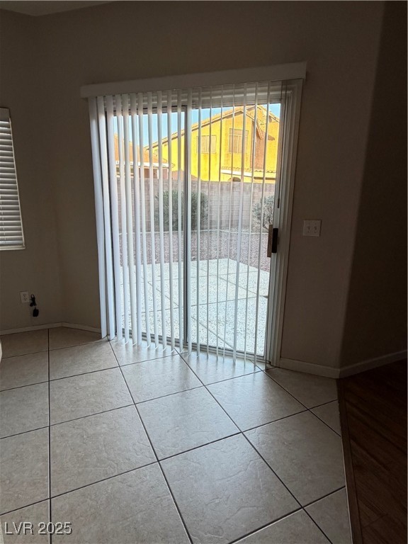 2924 Covatta Court North Las Vegas, NV 89086 - Photo 13 of 27 Empty room featuring light tile patterned floors and plenty of natural light
