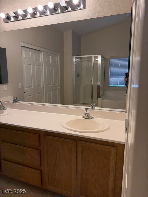 2924 Covatta Court North Las Vegas, NV 89086 - Photo 14 of 27 Full bath featuring a shower stall, tile patterned flooring, a garden tub, and vanity