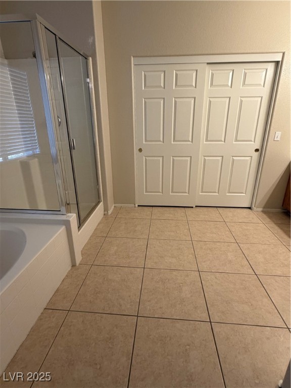 2924 Covatta Court North Las Vegas, NV 89086 - Photo 16 of 27 Bathroom with light tile patterned floors, a shower stall, and a garden tub