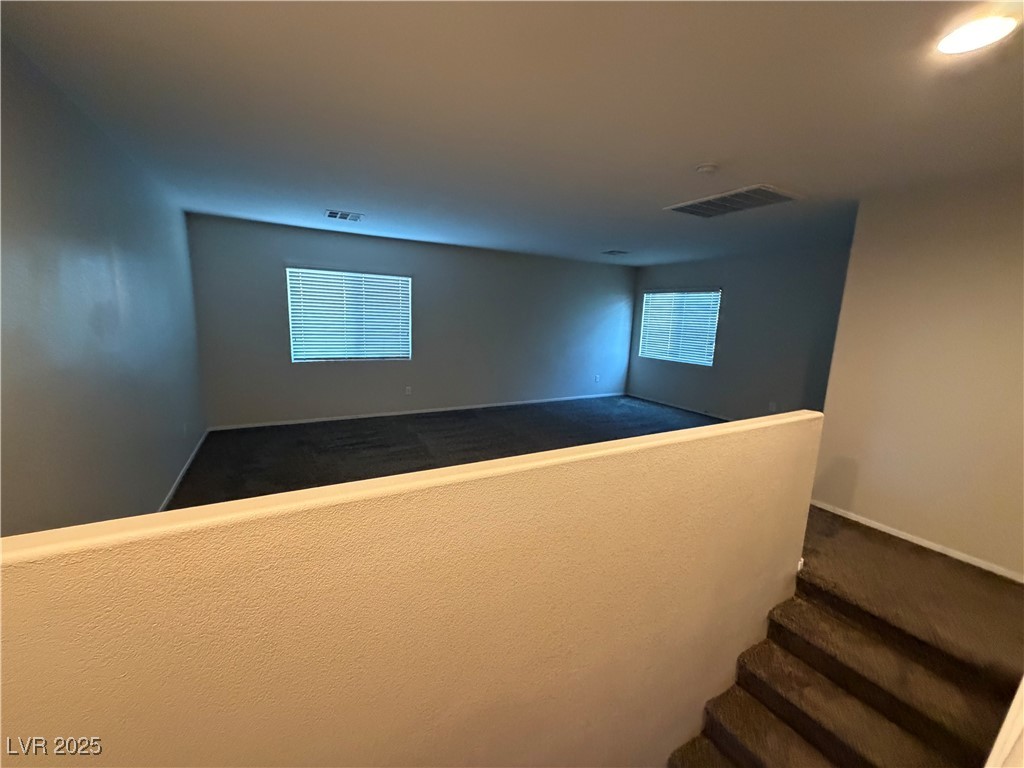 2924 Covatta Court North Las Vegas, NV 89086 - Photo 23 of 27 Staircase featuring carpet floors and baseboards