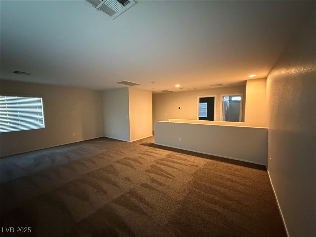2924 Covatta Court North Las Vegas, NV 89086 - Photo 24 of 27 Unfurnished room with dark colored carpet, plenty of natural light, and recessed lighting