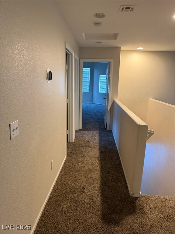2924 Covatta Court North Las Vegas, NV 89086 - Photo 25 of 27 Hall featuring a textured wall, dark carpet, and an upstairs landing