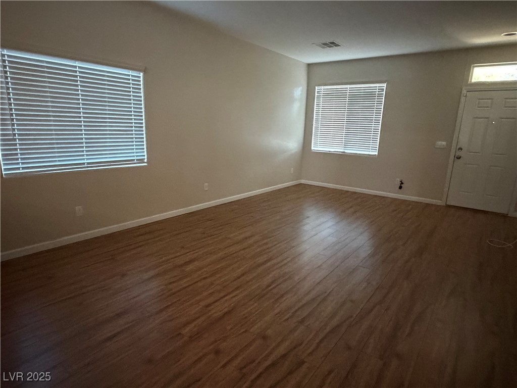 2924 Covatta Court North Las Vegas, NV 89086 - Photo 8 of 27 Empty room featuring dark wood finished floors and baseboards